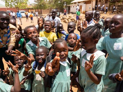 Children in Sudan making the Scout symbol