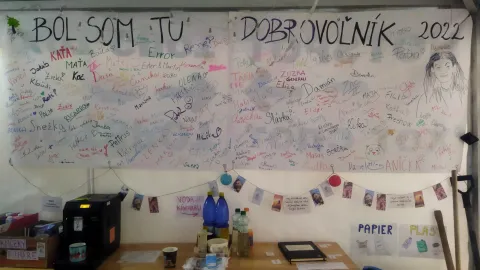 Wall with papers and drawings.