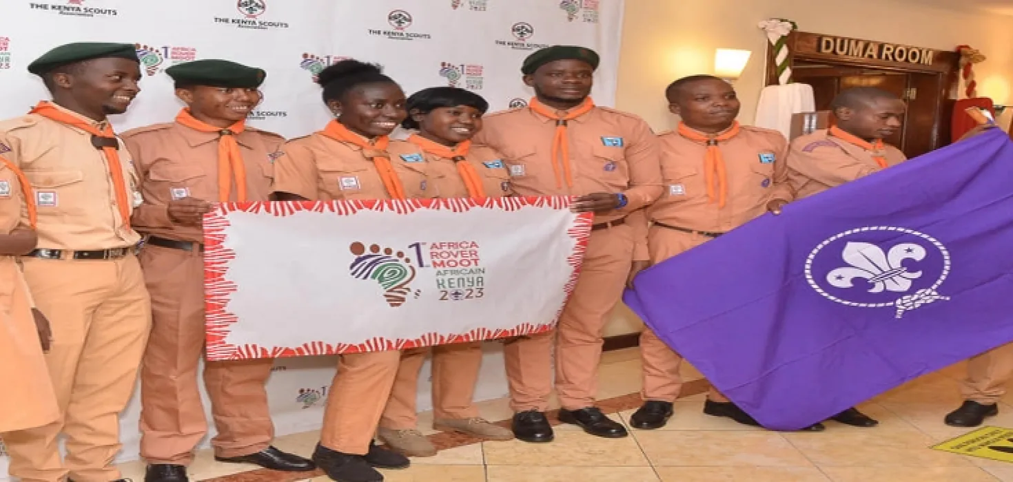 scouts holding the flag of the new moot logo