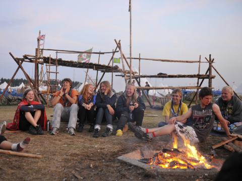 Scouts assis autour du feu de camp