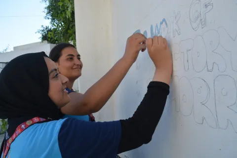 Two Arab Scouts write on a board during the Arab Scout Moot