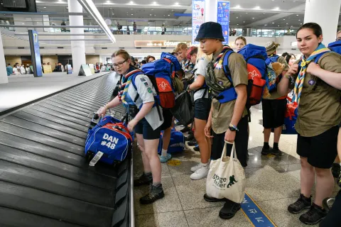 Scouts get their backpacks from the conveyor belt at Incheon Airport in Seoul, South Korea on their way to the 25th World Scout Jamboree